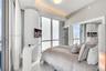 Floor-to-ceiling windows, built-in desk, recessed lighting, and mirrored closet doors
