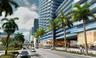 High-rise glass facade with curvilinear balconies, floor-to-ceiling glass exterior, stone-paved pedestrian entrance, and mature palm landscaping