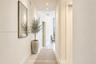 Hallway featuring recessed ceiling lighting, light-toned flooring, and neutral wall finishes