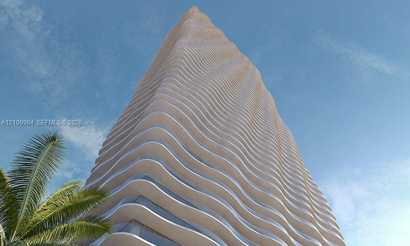 High-rise architectural exterior featuring a curvilinear facade, stacked undulating floor plates, and glass-encased balcony perimeters