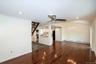 Unfurnished living room featuring dark wood-style floors, a baseboard heating unit, recessed lighting, a ceiling fan, and ornamental molding