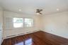 Spare room with a baseboard radiator, dark wood-style flooring, crown molding, a ceiling fan, and recessed lighting