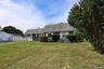 View of front facade featuring a front lawn and an attached garage