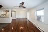 Unfurnished living room featuring a baseboard radiator, dark wood-type flooring, a ceiling fan, recessed lighting, and vaulted ceiling