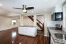 Kitchen featuring stainless steel appliances, white cabinetry, dark stone countertops, dark wood-type flooring, and recessed lighting