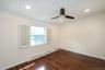 Empty room with a baseboard heating unit, dark wood-type flooring, crown molding, recessed lighting, and a ceiling fan