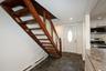 Foyer with baseboard heating, stone tile floors, stairway, recessed lighting, and ornamental molding