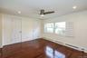 Unfurnished bedroom featuring a baseboard heating unit, ornamental molding, recessed lighting, dark wood-style floors, and a ceiling fan