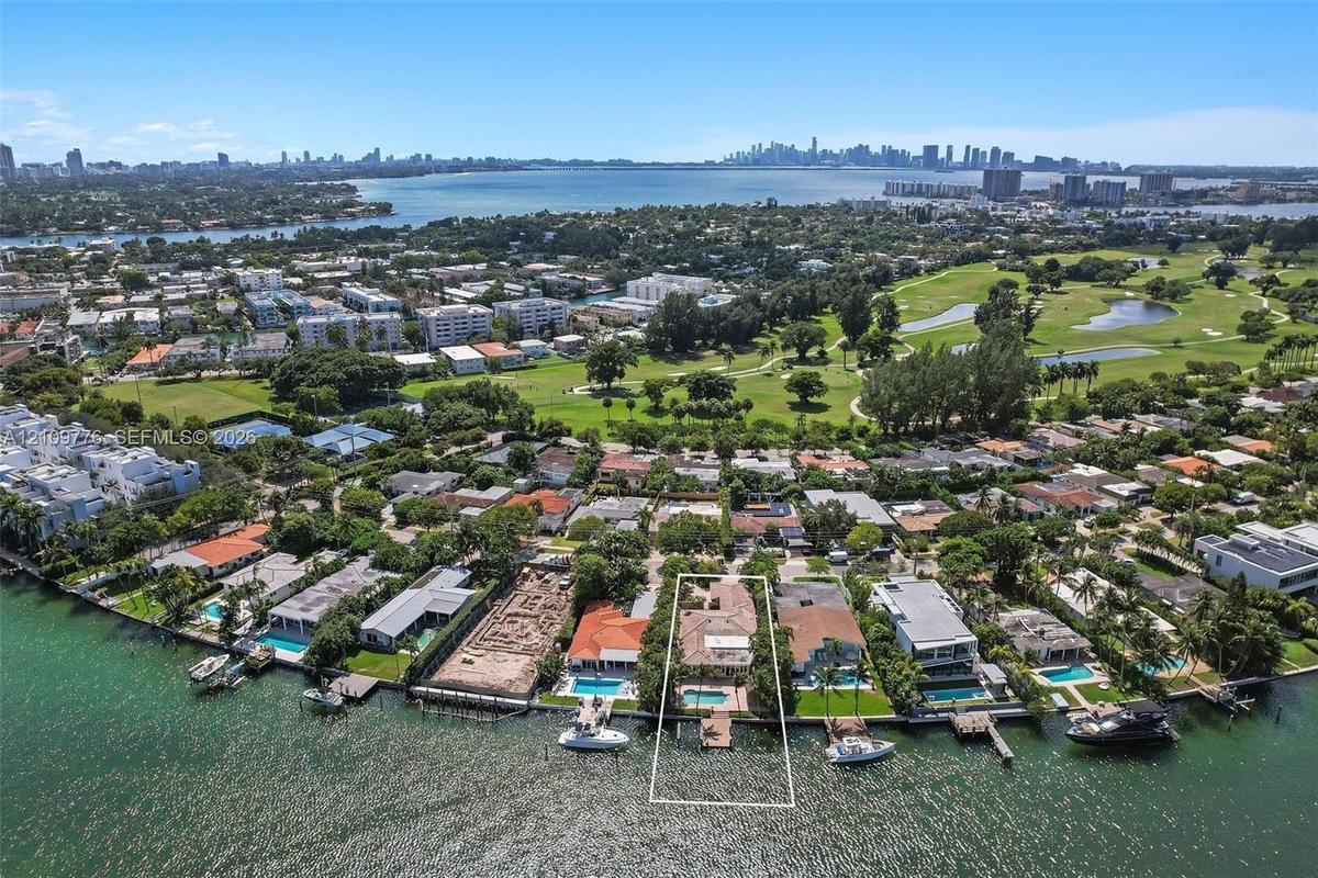 Waterfront property featuring a private boat dock, swimming pool, and direct shoreline access