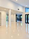 Open interior featuring large-format tile flooring, vaulted ceilings, recessed lighting, access to the garden & terrace.