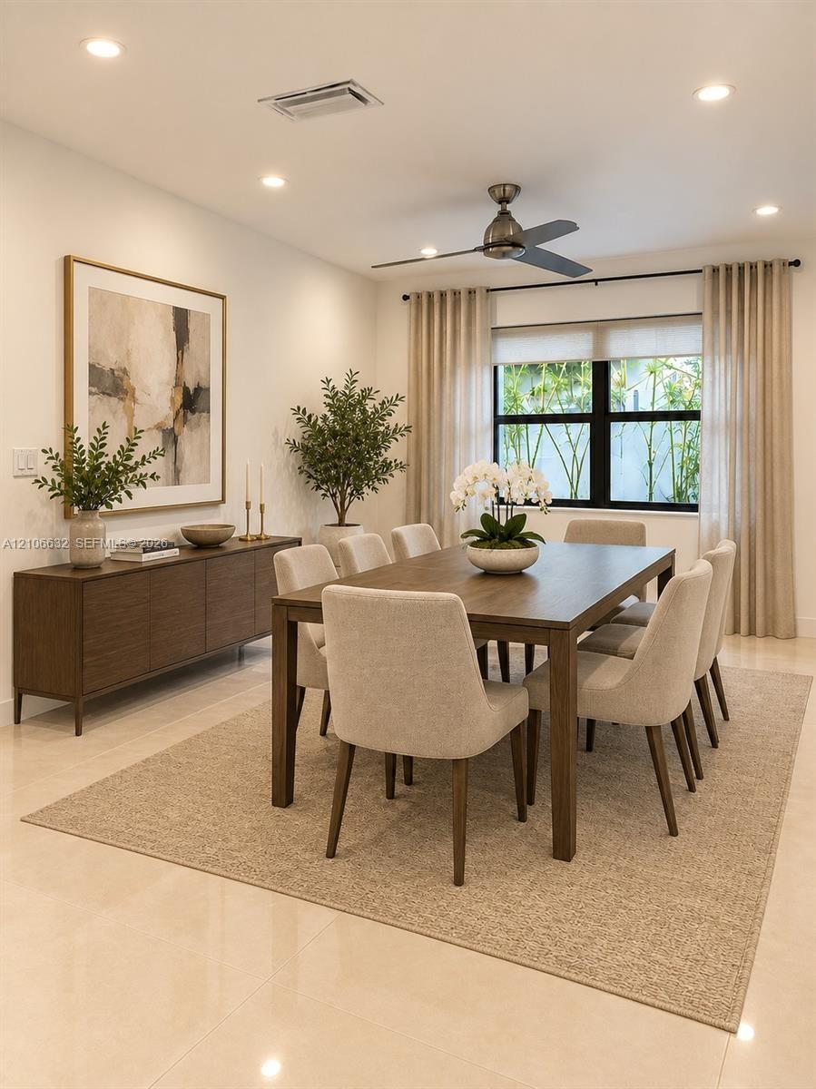 Neutral-toned interior space featuring polished tile flooring, recessed ceiling lighting, and a modern metal ceiling fan