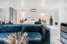 Spacious interior featuring high-gloss flooring, recessed lighting, and a wall-mounted climate control unit