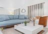 Neutral interior featuring white walls, wall-mounted ductless air conditioning unit, and metal curtain rods