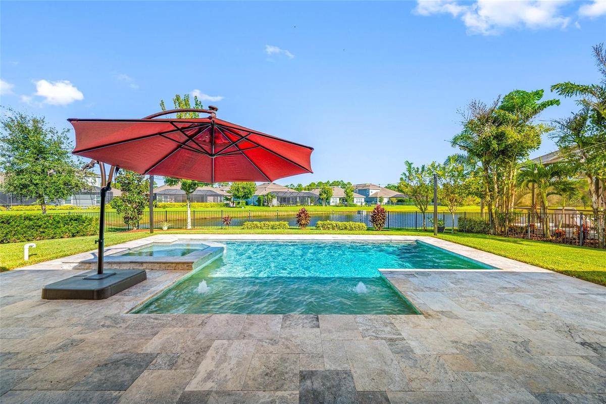 Backyard Pool with Infinity edge Spa on pond