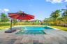 Backyard Pool with Infinity edge Spa on pond
