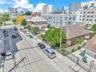 Corner lot property featuring a masonry exterior, private perimeter fencing, and established mature landscaping