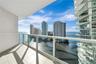Private balcony featuring white tile flooring and a glass panel railing