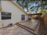 paver side of home with entertainment deck