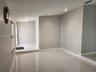 Polished neutral-toned flooring, recessed ceiling lighting, and wall-mounted fixture