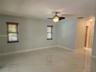 Interior space featuring polished stone-finish flooring, recessed lighting, a ceiling fan with integrated light fixture, and horizontal blinds on wind