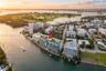 Waterfront mid-rise building featuring a rooftop pool, private boat slips, and balcony terraces