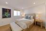 Neutral interior featuring light-tone wood-finish flooring, recessed lighting, and a window with a retractable roller shade