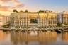 Waterfront residential building featuring floor-to-ceiling glass exteriors, expansive private balconies, a rooftop garden, and multiple deep-water boa
