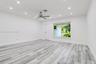 Interior space featuring wood-finish flooring, recessed lighting, and a metal-finish ceiling fan