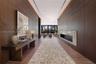 Entry hall featuring floor-to-ceiling wood paneling, recessed lighting, linear fireplace with a stone-surround, and wide-plank wood-finish flooring