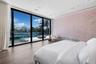 Floor-to-ceiling glass sliding doors, wood-finish flooring, recessed ceiling lighting, and custom floral-motif wall covering