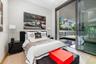 Floor-to-ceiling sliding glass panels, recessed ceiling lighting, and wood-finish flooring