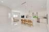 Kitchen featuring high-gloss cabinetry, stone-finish countertops, waterfall-edge island, polished tile flooring, and recessed lighting