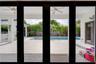 Covered patio featuring large-format tile flooring and ceiling fans, opening to an outdoor swimming pool area with privacy fencing