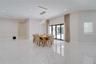 Large-format, polished stone flooring featuring distinct veining, multi-pendant glass orb chandelier, recessed ceiling lighting, and floor-to-ceiling 
