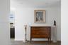 Neutral-toned walls and wood-finish flooring with recessed ceiling lighting