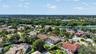 Two-story residence featuring a tile roof, an enclosed swimming pool, and a private rear yard with mature landscaping