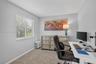 Room featuring neutral wall tones, wall-to-wall carpeting, and a window with horizontal blinds