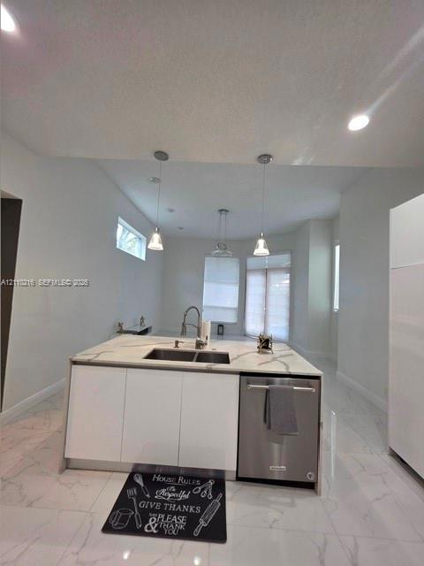 Kitchen island with a light-toned stone-patterned countertop, double-basin undermount sink, integrated stainless steel dishwasher, sleek white cabinet