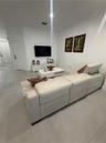 Neutral tile flooring, recessed lighting, and solid-core interior doors