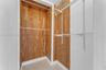 Walk-in closet featuring cedar-lined interior walls, integrated wire shelving, and metal garment rods