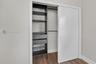 Reach-in closet featuring custom organizational cabinetry, including integrated shelving, dual storage drawers, and metal wire pull-out baskets, compl