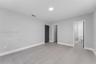 Neutral interior space featuring wood-finish flooring, recessed lighting, and solid-core doors