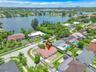 Aerial perspective featuring a shingle-style roof, corner lot placement, and proximity to a lakefront