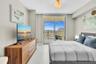 Floor-to-ceiling sliding glass doors open to a private balcony