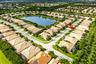 Aerial perspective featuring tile roofing, concrete paved streets, and residential landscaping within a suburban community