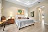 Tray ceiling, recessed lighting, and wood-finish flooring