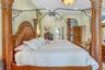 Room featuring recessed lighting, a decorative arched entryway, and raised panel wooden doors