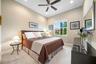 High ceilings featuring a central ceiling fan with integrated lighting, neutral wall palette, plush wall-to-wall carpeting, and a multi-pane window wi