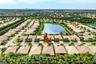 Aerial perspective of a residential property featuring a tiled roof and proximity to a central lake