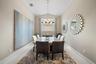 Vaulted ceilings, large-format tile flooring, and a multi-arm metallic chandelier